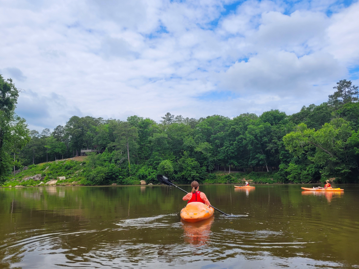 guests kayak around a bend of the chattahoochee river