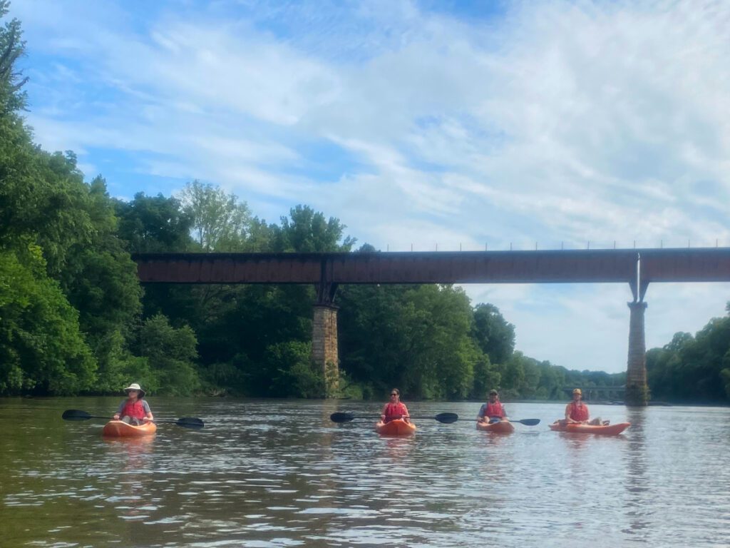 A group kayaking on the Chattahoochee on a sunny day