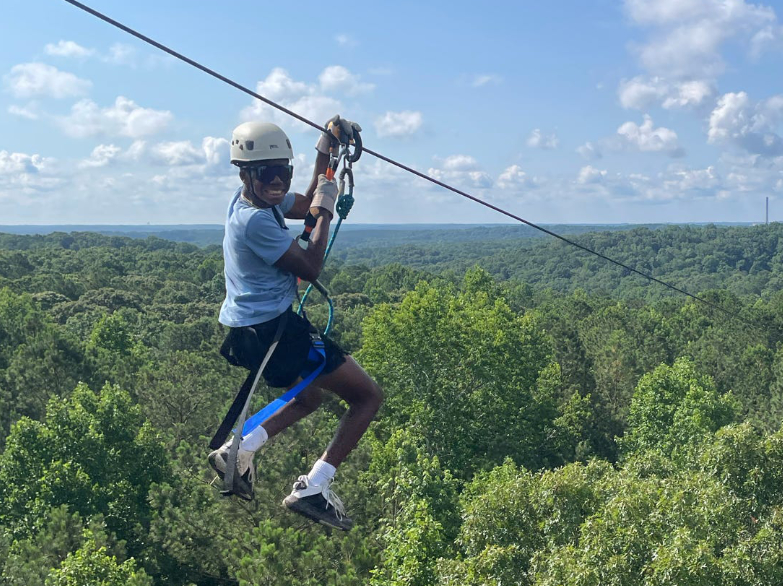 Camper Zipping down Screaming Eagle - Level 4_Specialty Tours